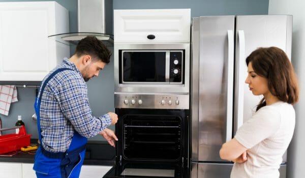 technician repairing the oven