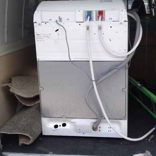 Image of the back of a washer or dryer inside the nationwide appliance repair service vehicle