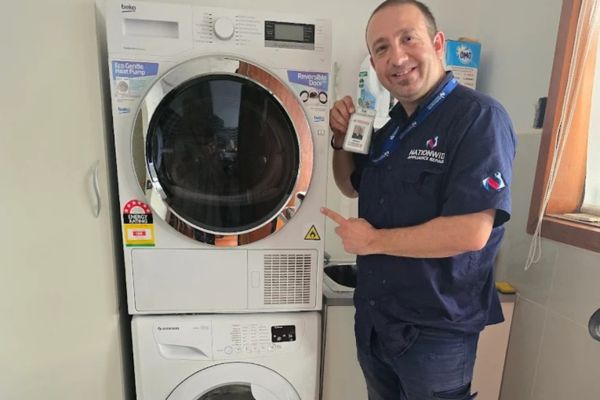 NWAR Technician repairing washing machine not draining or spinning NWAR Technician repairing washing machine not draining or spinning